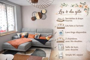 a living room with a gray couch and a wall with a poster at Pause et vous à la mer in Fécamp