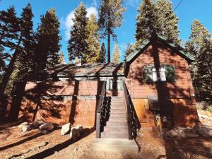 a small wooden building with stairs leading up to it at Campo Carnelian in Carnelian Bay