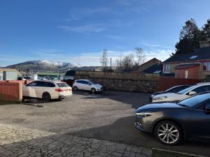 a group of cars parked in a parking lot at Central 1BR Apt with Parking in Auchterarder