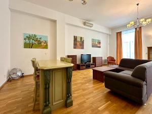 a living room with a couch and a table at Slunecni Lazne Apartments in Karlovy Vary