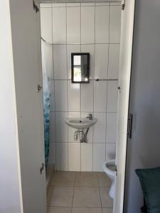 a bathroom with a sink and a toilet at Legacy lodge in Goodwood