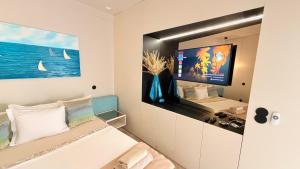 a living room with a tv and a couch at Spacious studio apartment in the heart of Cascais historic center in Cascais
