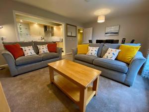 a living room with two couches and a coffee table at Kirkwall town centre apartment 3 in Kirkwall