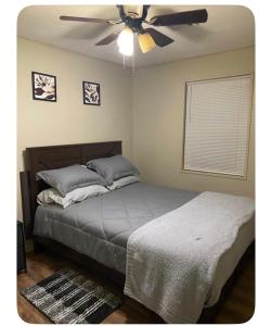 a bedroom with a bed and a ceiling fan at Heavenly Home in Monroe