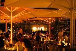 a group of people sitting at tables in a restaurant at Hotel Vista di Capri in Massa Lubrense
