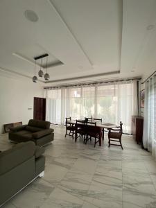 a living room with a table and a couch at Le grand luxe in Cotonou