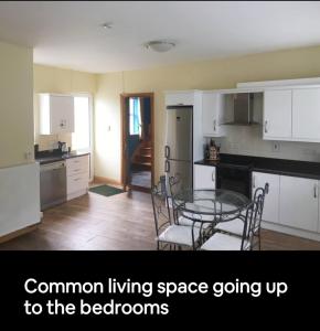 a kitchen with a table and chairs in a room at Curraghchase Cottage in Limerick +10 photos