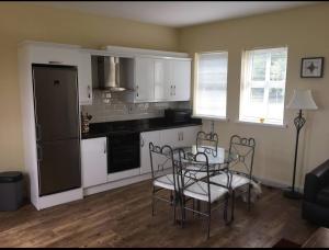 a kitchen with a table and chairs in a room at Curraghchase Cottage in Limerick