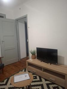 a living room with a flat screen tv on a table at Casa do Alto da Torre in Abrantes
