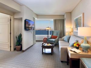 a living room with a couch and a table at Seaport Hotel® Boston in Boston