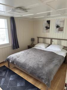 a bedroom with a large bed and a window at Hotel Central - Self Check-in in Luchsingen