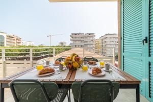 a table with a bowl of fruit on a balcony at Penelope al mare 20 in Alba Adriatica