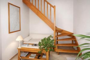 a living room with a staircase and a table at De Cian in Saint-Valéry-sur-Somme