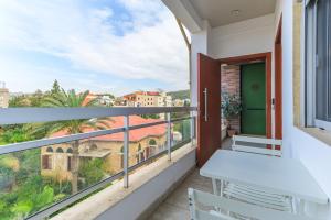 a balcony with a view of a city at City Rental London theme in Batroûn