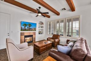 a living room with a couch and a fireplace at Poolside Greens 3BR Legacy Villa in La Quinta