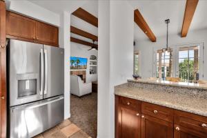 a kitchen with a stainless steel refrigerator and a living room at Poolside Greens 2BR Legacy Villa in La Quinta +33 photos