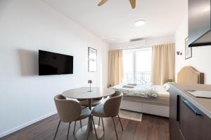 a kitchen and living room with a table and chairs at Castle Studio 7 Bojnice in Bojnice