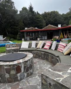 a group of pillows sitting on a stone patio at Sueño Verde EcoVilla in Cerro Verde