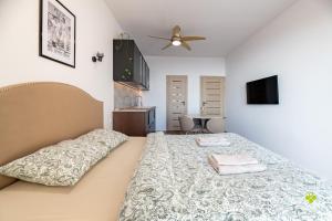 a bedroom with a bed with two towels on it at Castle Studio 7 Bojnice in Bojnice