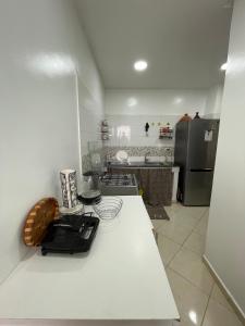 a kitchen with a white counter top and a refrigerator at Appartement Moderne à Temara in Temara