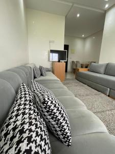 a living room with a gray couch with pillows at Appartement Moderne à Temara in Temara