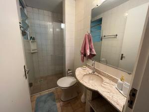 a bathroom with a sink and a toilet and a mirror at AP perto do HSVP com estacionamento in Passo Fundo +9 photos