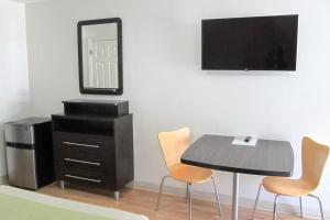 a dining room with a table and chairs and a dresser at Motel 6 Augusta GA Fort Gordon in Augusta