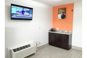 a room with a flat screen tv on the wall at Motel 6 Augusta GA Fort Gordon in Augusta