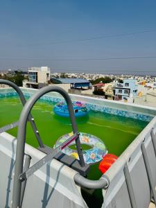 a balcony with a water slide on a roof at LUXE Penthouse 4BHK with Swimming pool in Mysore