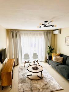 a living room with a couch and a table at 12th on The Bay Apartment in Richards Bay