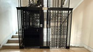 a black gate in a hallway with stairs at Home lab studio in Córdoba