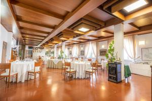a banquet hall with white tables and chairs at Hotel Vittoria in Porto Santo Stefano