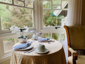 a table with a white table cloth and a window at La vanguardia by Don Ramon Hotel Boutique & Spa in Canela
