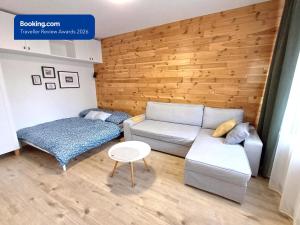 a living room with a couch and a bed at Apartman Point in Štrba