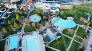 an aerial view of a building with a swimming pool at SERENITAS Apartment RIVA PARK in Dunajská Streda