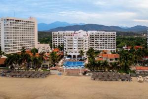 a view of a resort with a pool and buildings at Villa 1 en Hotel Tesoro Ixtapa in Ixtapa