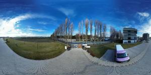 a skate park with a skate ramp and a building at SERENITAS Apartment RIVA PARK in Dunajská Streda