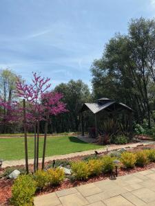 a gazebo in a park with trees and flowers at Yosemite's Inn the Woods in Ahwahnee
