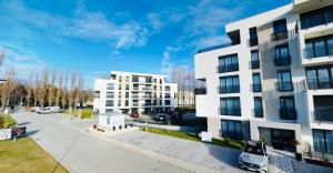 an apartment building with a car parked in front of it at SERENITAS Apartment RIVA PARK in Dunajská Streda