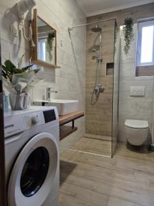 a bathroom with a washing machine and a sink at Apartments Leona in Neum +103 photos