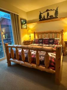 a bedroom with a wooden bed in a room at Yosemite's Inn the Woods in Ahwahnee
