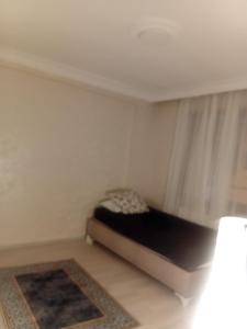 a small bedroom with a bed and a window at Edebiyat Apartments in Istanbul +7 photos