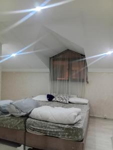 two beds in a room with lights on the ceiling at Edebiyat Apartments in Istanbul
