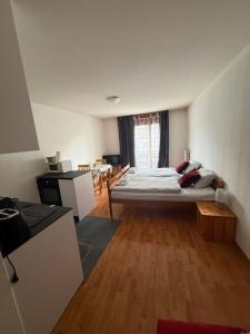 a large bedroom with a bed and a table at Résidence « Les Crêtes » in Torgon