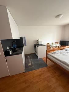 a room with a kitchen and a bed in it at Résidence « Les Crêtes » in Torgon