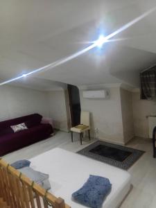 a living room with a couch and a light on the ceiling at Edebiyat Apartments in Istanbul