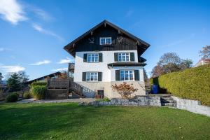 a large white house with a black roof at ღLIBORIA I Alpenblick Landhaus in Uffing