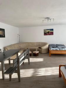 a living room with a couch and a table at Domek Ranczo in Mochnaczka Wyżna