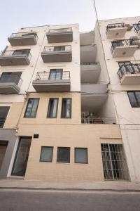 an apartment building with balconies on the side of it at Twin Apartment in St. Julianʼs