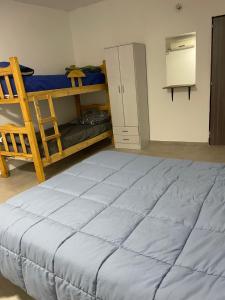 ein Schlafzimmer mit einem großen Bett und Etagenbetten in der Unterkunft Herrera in Caucete